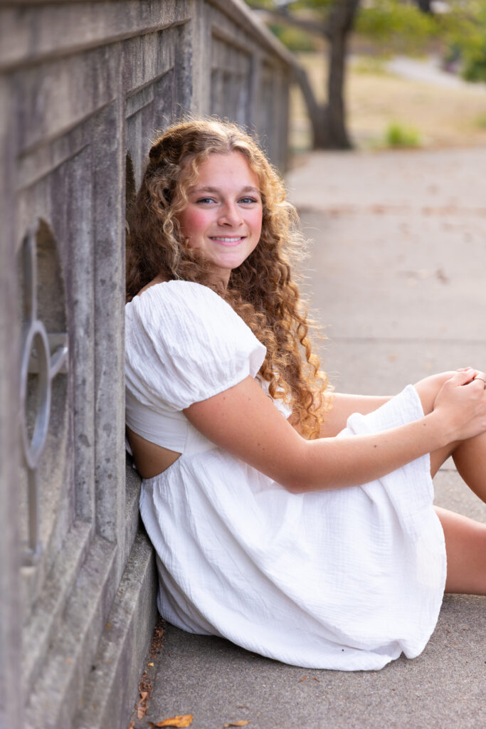 high School senior girl posing on bridge in Eden Park