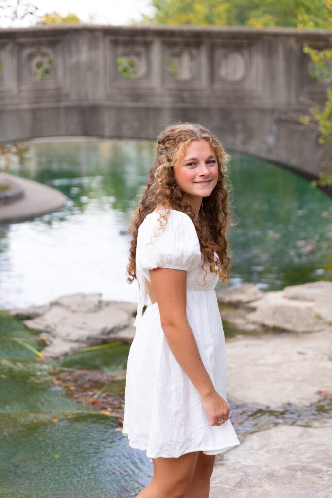 high School senior girl posing on bridge in Eden Park