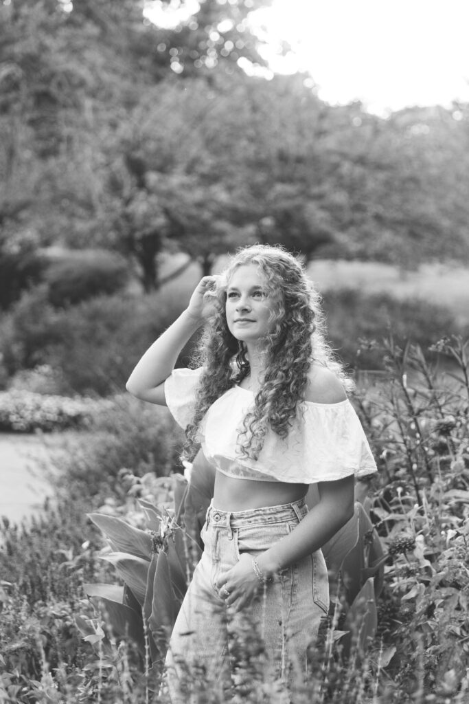 high School senior girl posing in front of golden tall grass in Eden Park
