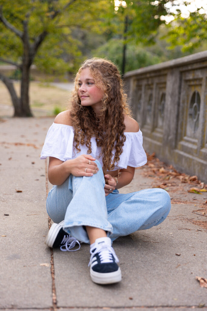 high School senior girl posing on bridge in Eden Park
