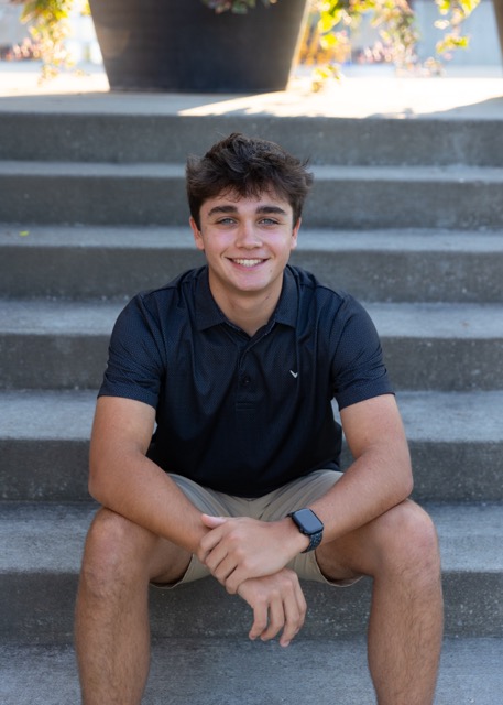 high school senior boy sitting on a stairs at Summit Park Blue Ash Ohio