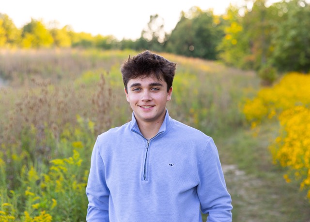 high school senior boy in wild flowers at Summit Park Blue Ash Ohio