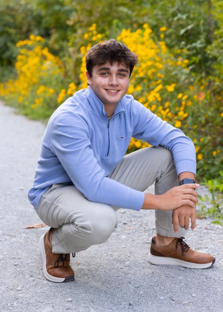 high school senior boy with yellow wild flowers at Summit Park Blue Ash Ohio