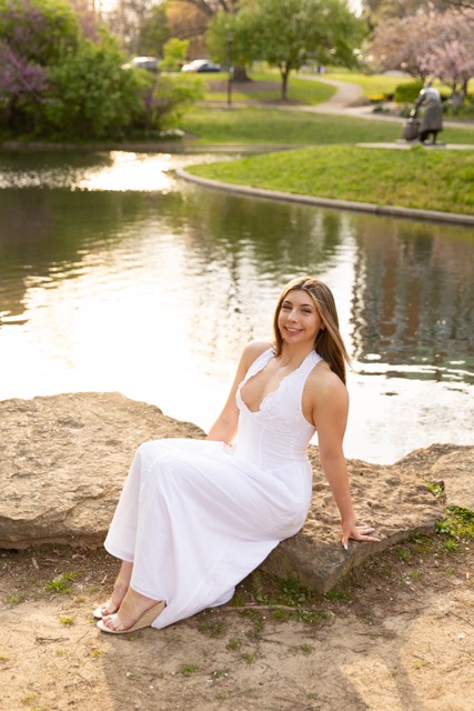 high school senior girl posing by the pond in white dress in Eden Park
