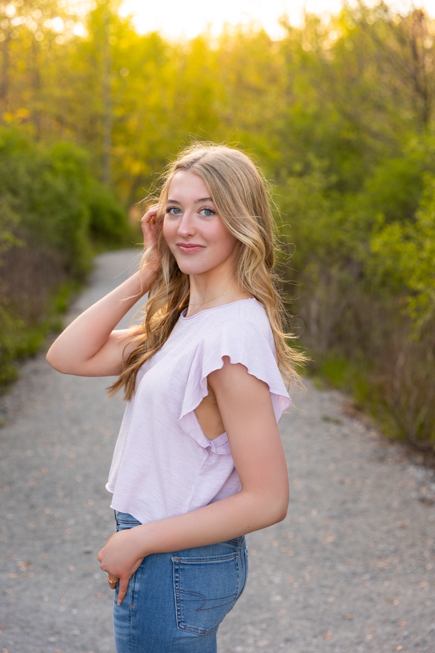 young girl posing holding her hair senior photos in Summit Park