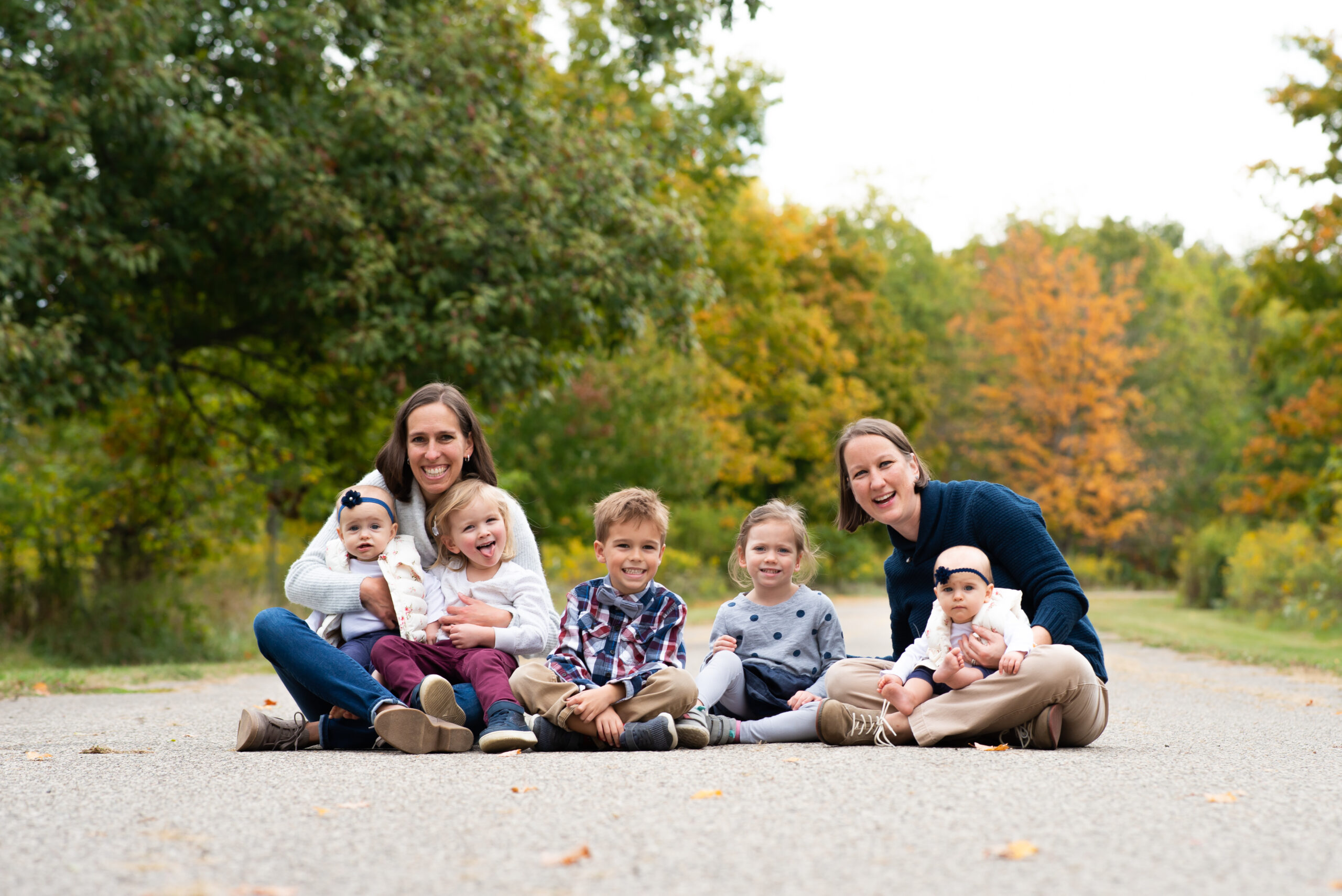 family with 5 kids, sitting in a park in the fall in Sharon woods 