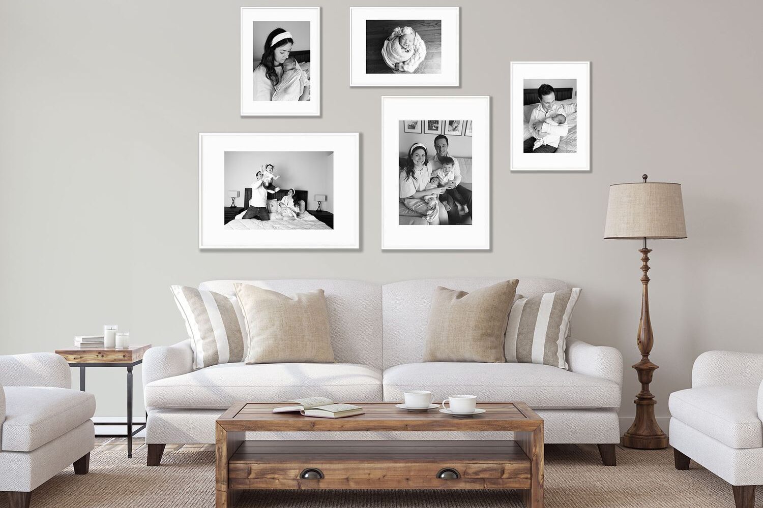 Modern living room with a neutral color scheme, featuring a sofa, armchairs, and a wooden coffee table, decorated with a gallery wall of black and white framed photographs.