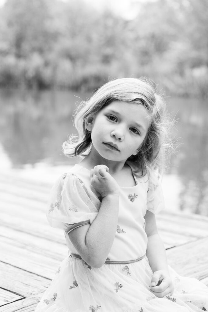 little girl posing in front of a pond in pioneer park