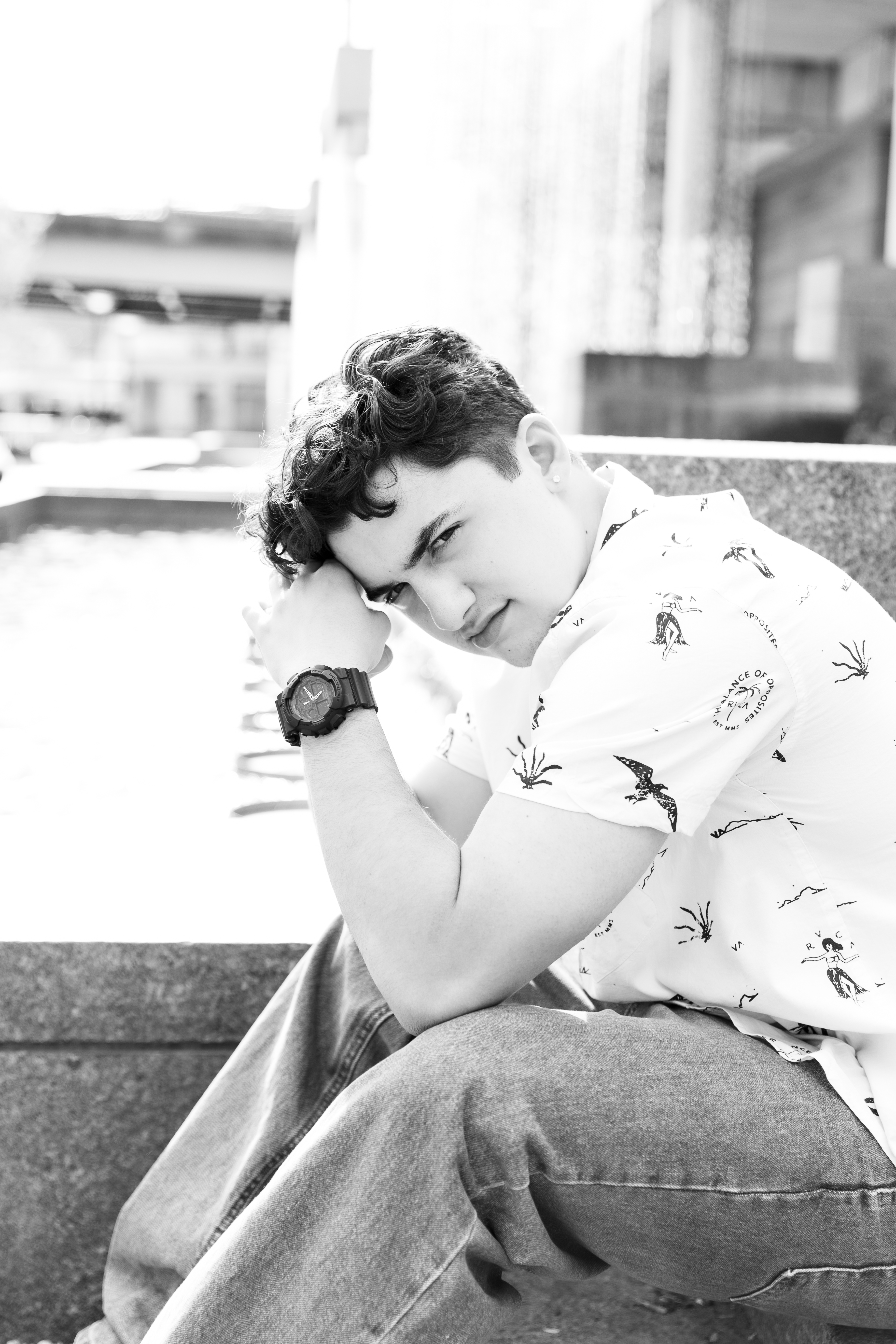 hogh school senior by posing in front of waterfall in Cincinnati Downtown