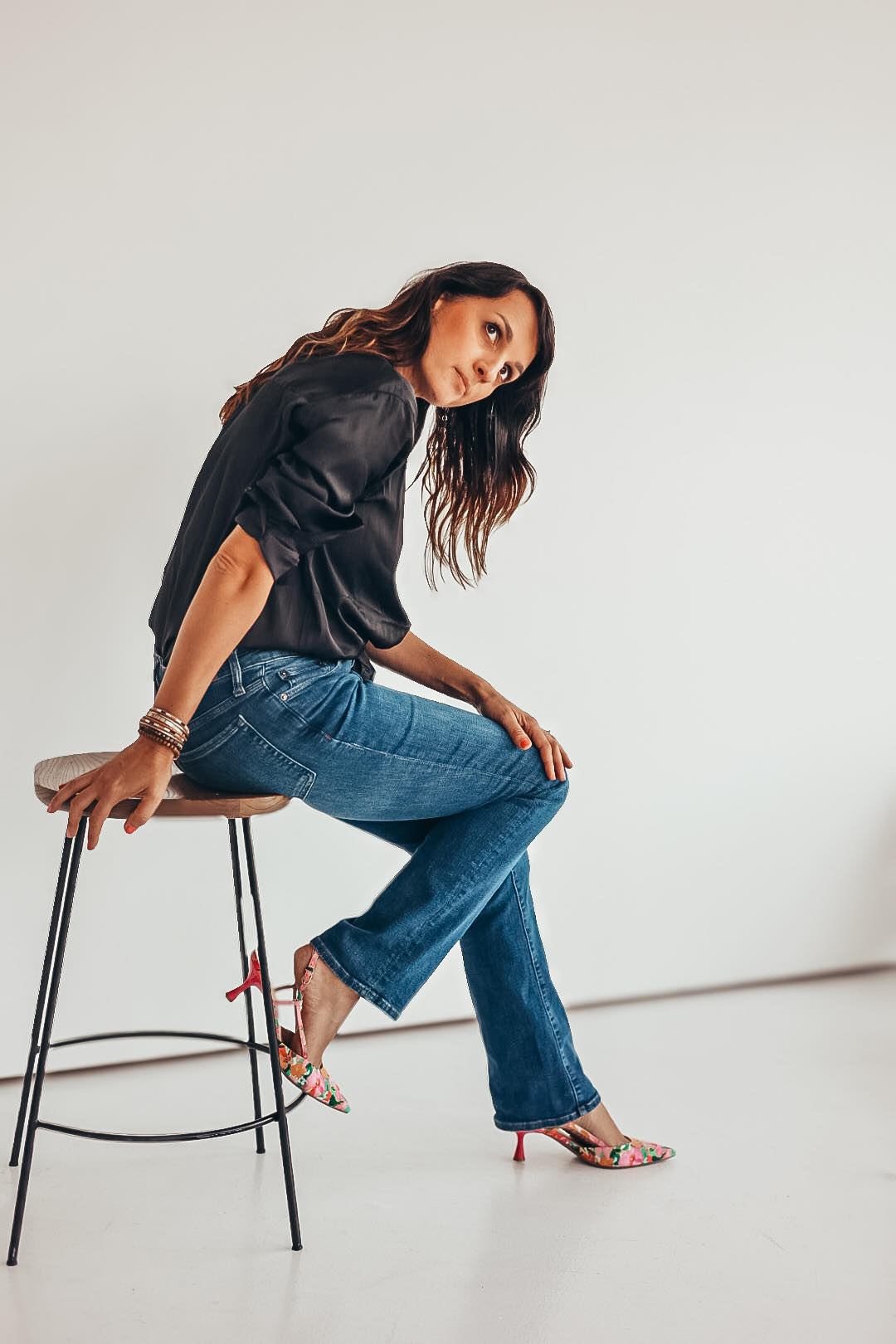 Agnes Kindberg leaning over sitting in a chair posing for headshots