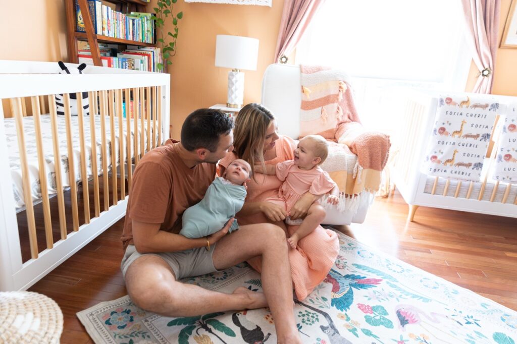 family posing in baby's nursery