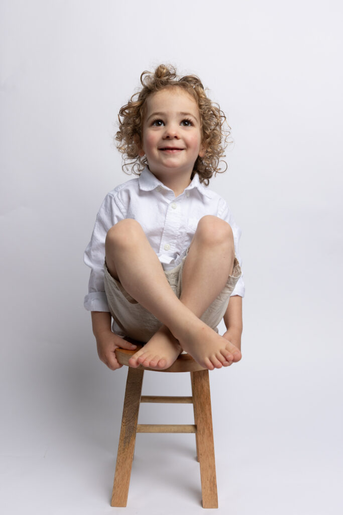 cute toddler posing sitting on chair