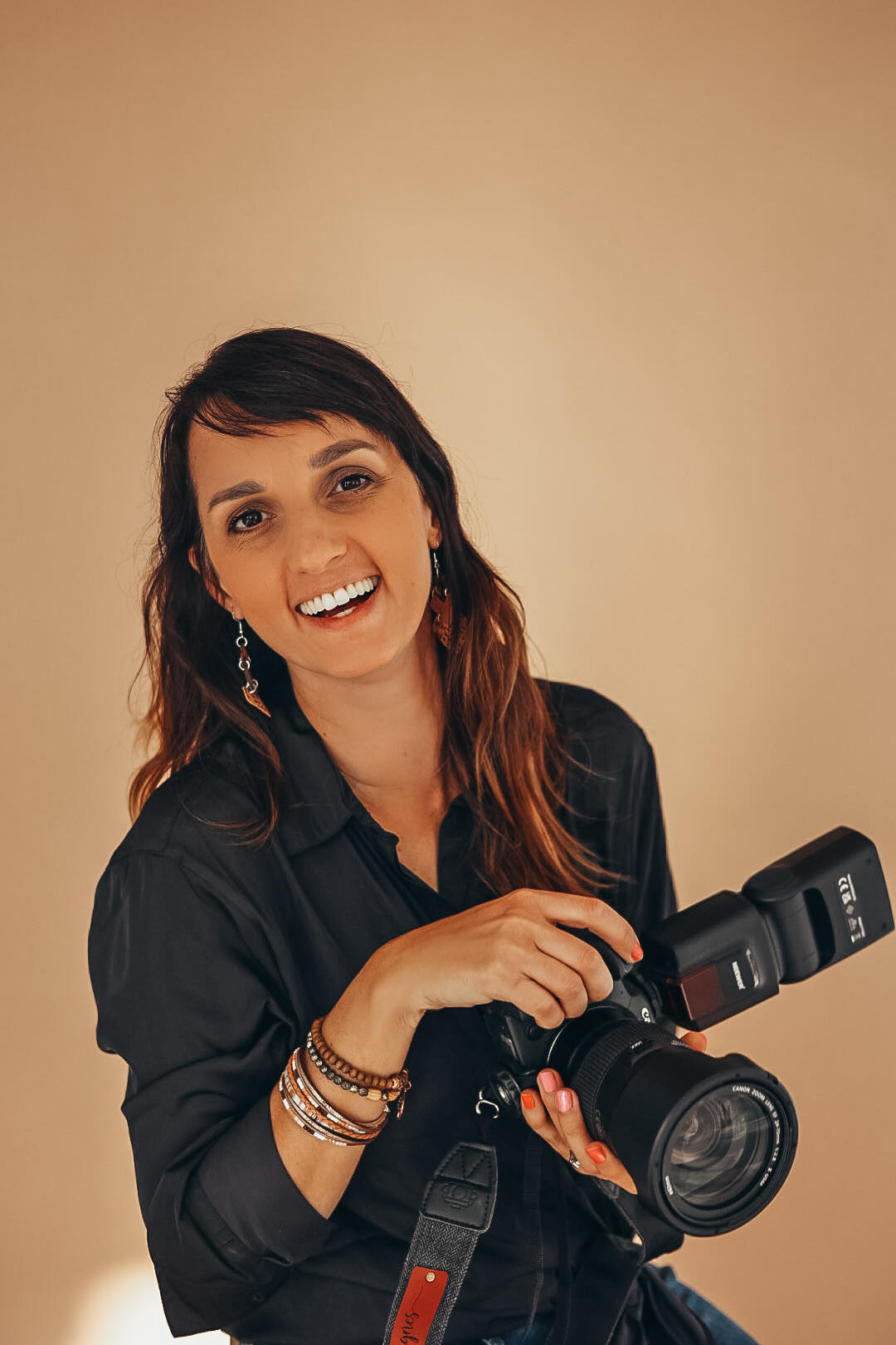 Agnes Kindberg Photographer smiling holding a camera