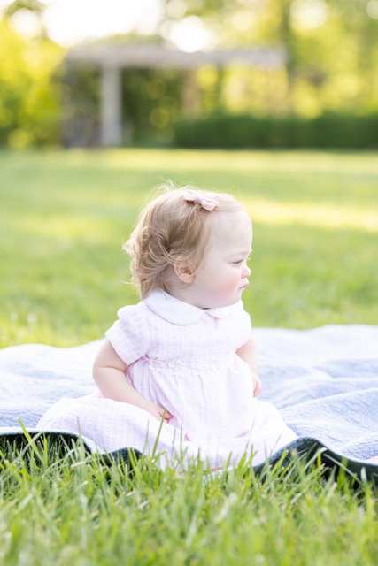 baby girl sitting on a blanket during a photoshoot at Ault Park