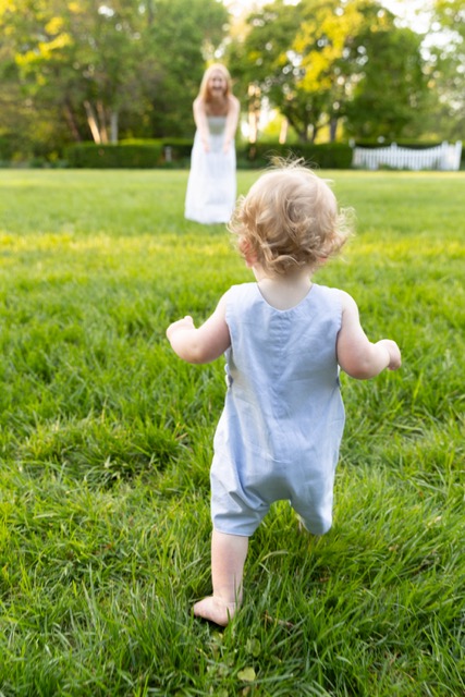 toddler walking away from camera at a photo shoot in Ault Park